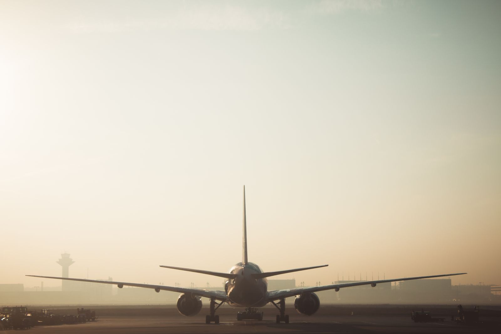 Airliner on a runway in morning haze
