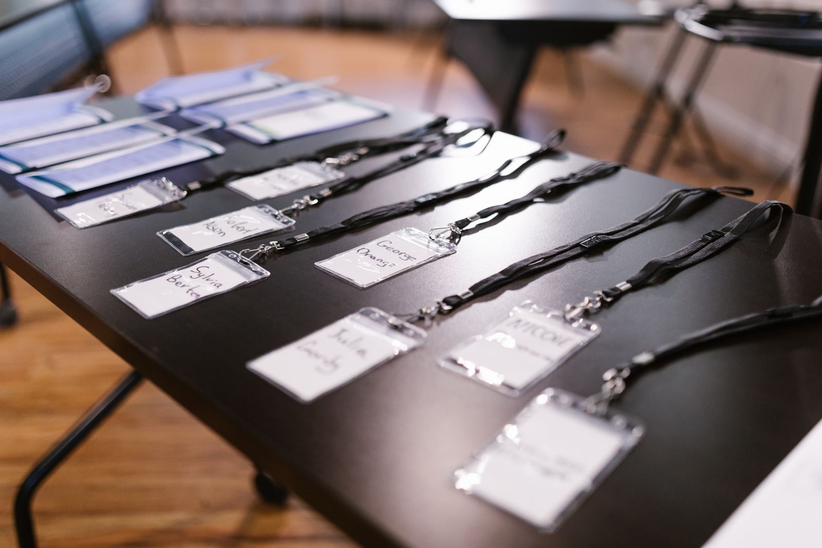 Name badges on lanyards laid out on a table, the everyday version of the IATA card agents ask about when they search how much is an IATA card